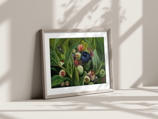A framed art print featuring an acrylic painting of wild blueberries on a wood panel, displayed on a wall in a well-lit room with natural lighting.