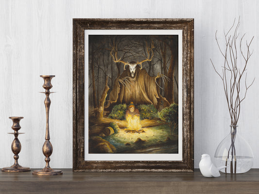 A digital art print depicting a spooky forest scene with a central figure, and looming wendigo, framed in a wooden frame, displayed on a wall.