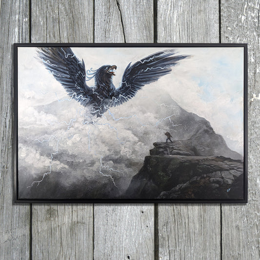 Framed original painting of Pamola, a thunderbird spirit with wings spread and lightning streaking through storm clouds above a rocky mountain ledge, displayed in a black frame on weathered gray wooden boards.