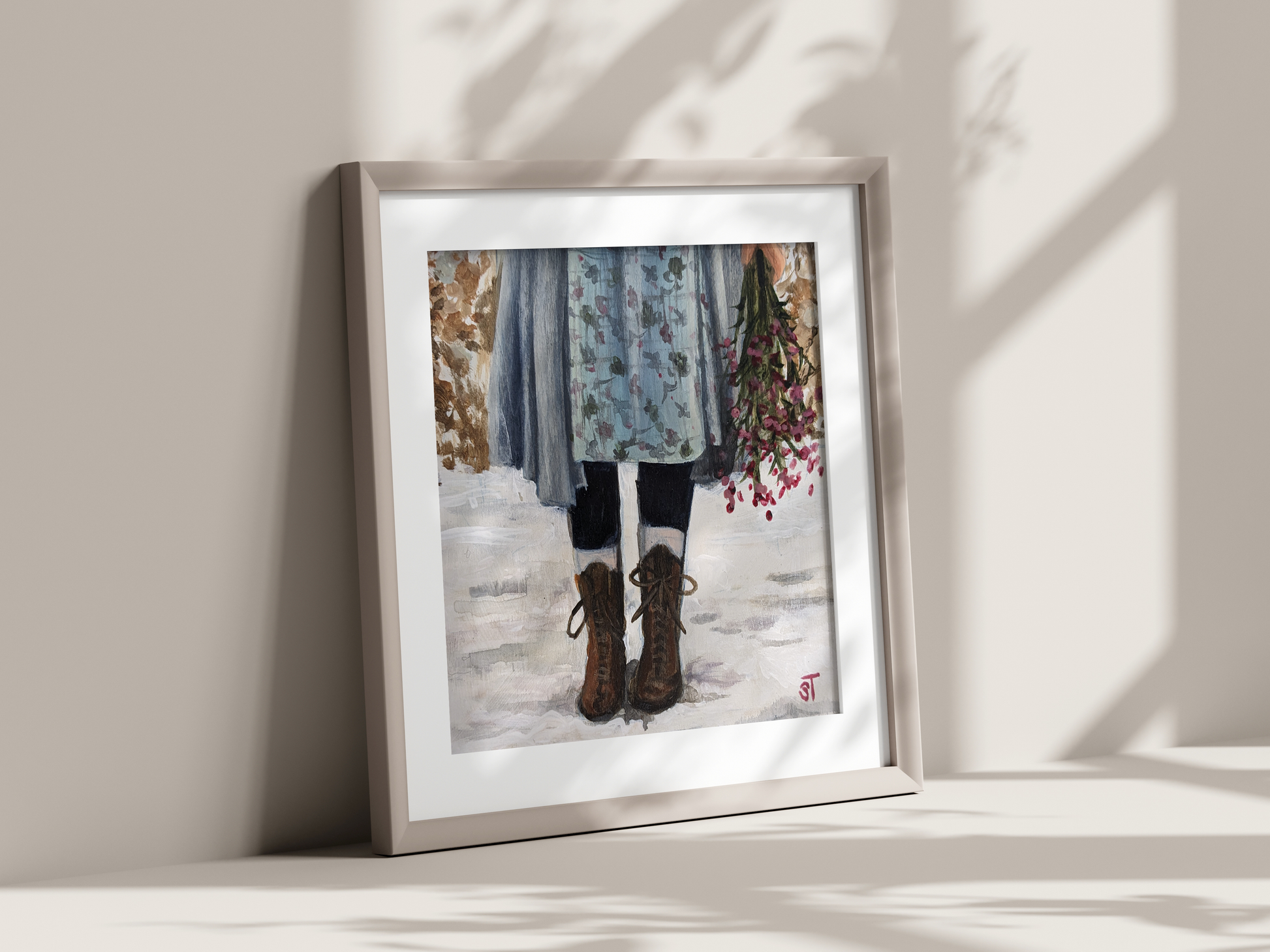 A framed art print featuring a winter scene with a young girl in vintage-style boots and a floral skirt, standing in the snow with a bundle of flowers.