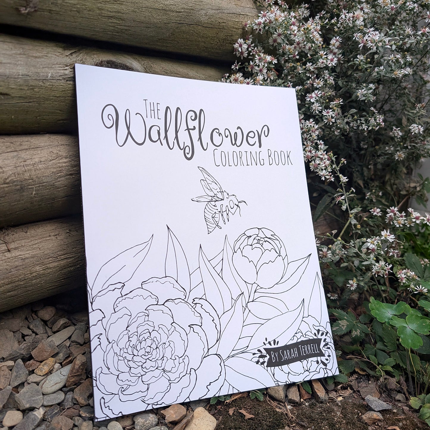 Cover of The Wallflower Coloring Book featuring floral line art and a bee illustration by Sarah Terrell.