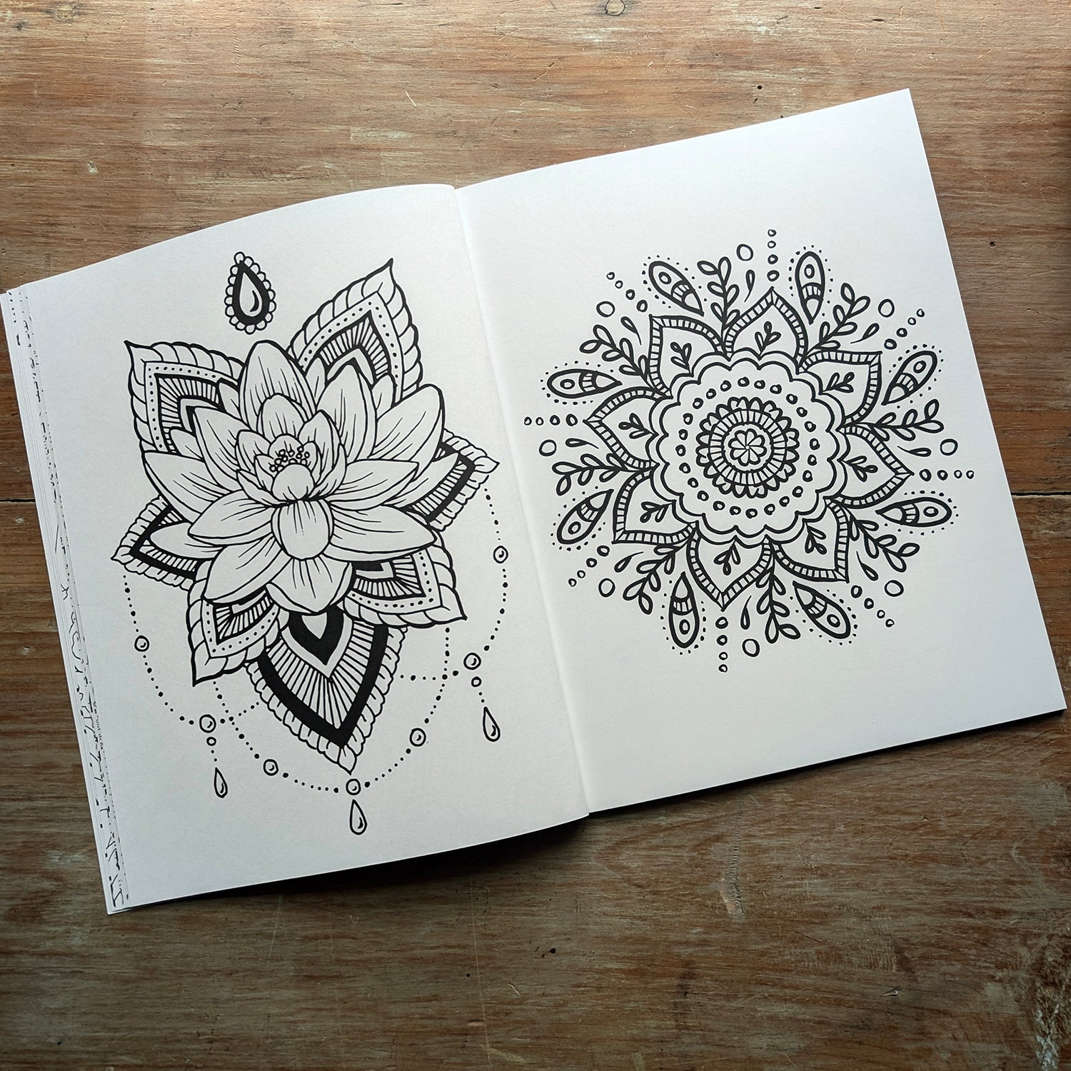 Sample interior coloring book spread featuring lotus flower and mandala-style botanical designs.
