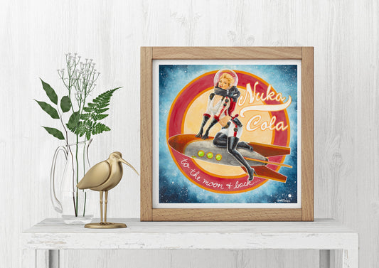 A framed art print of the Nuka Cola Girl sitting on a shelf with a plant and a decorative bird figure to its left.
