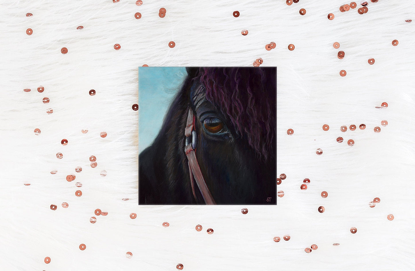 A greeting card with a reproduction of an acrylic painting of a close-up view of a horse's eye, surrounded by decorative sequins.